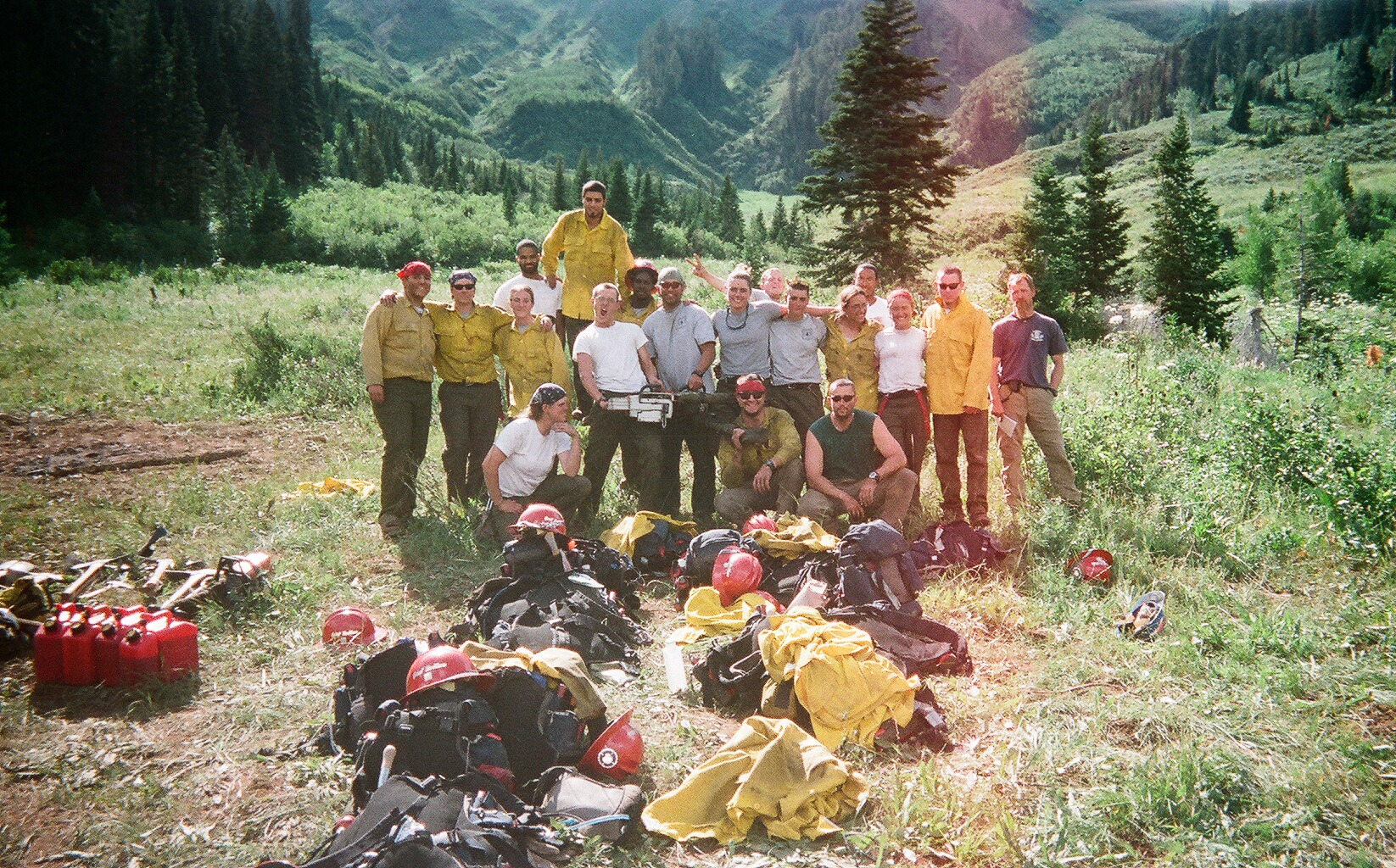 Great Northern fire crew posing with firefighting equipment in a mountain landscape